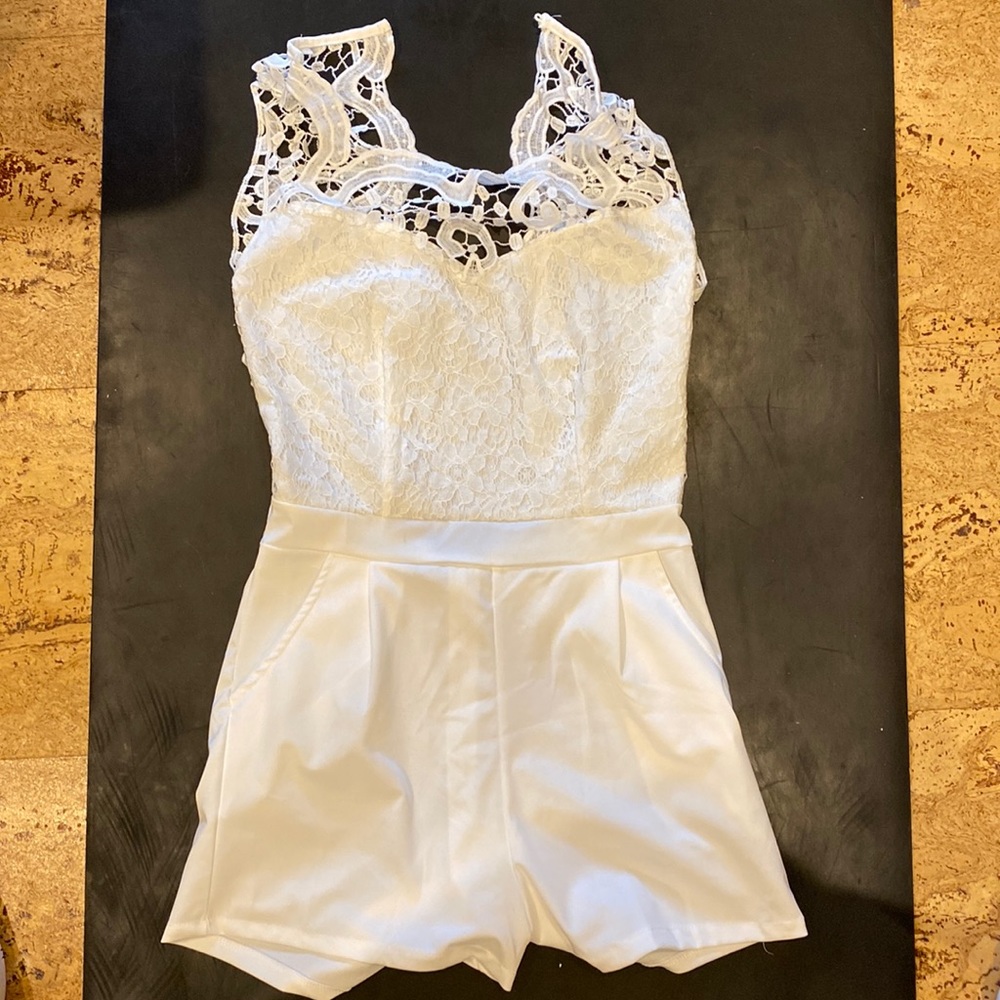White lacy romper with open back.
